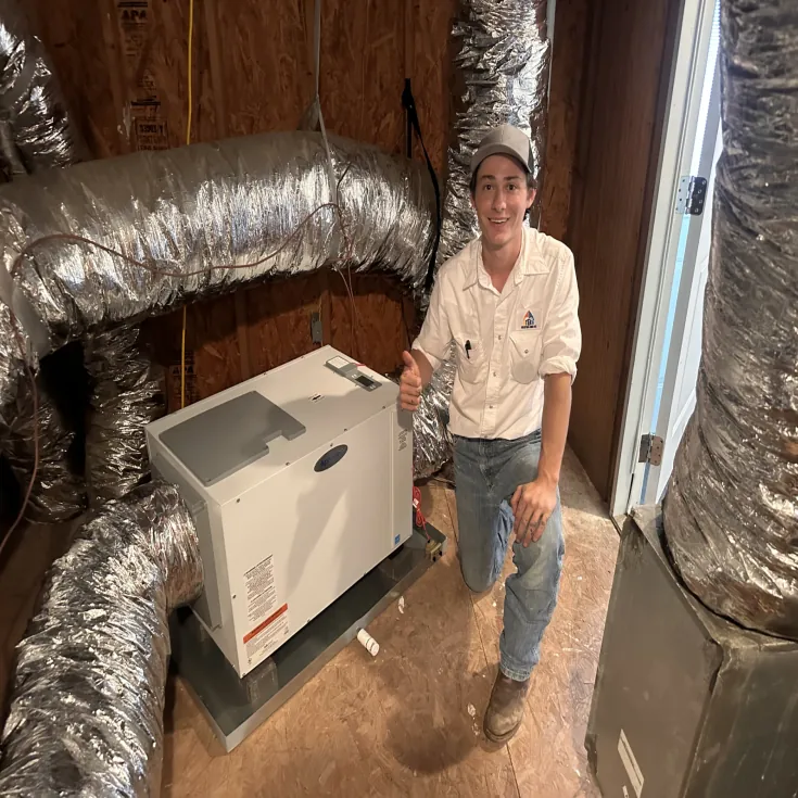 Technician with a newly installed whole-home dehumidifier